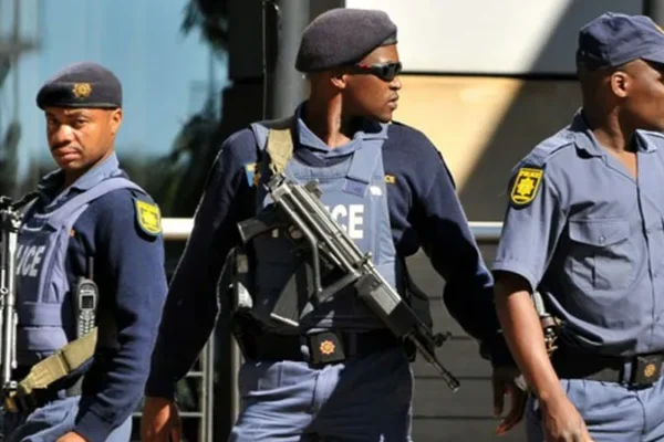 Police officers at the scene of a deadly mass shooting in an informal settlement near Johannesburg, South Africa, where 12 people were killed by armed attackers.