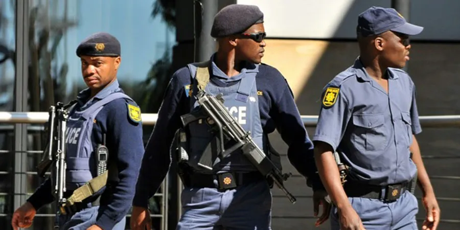 Police officers at the scene of a deadly mass shooting in an informal settlement near Johannesburg, South Africa, where 12 people were killed by armed attackers.