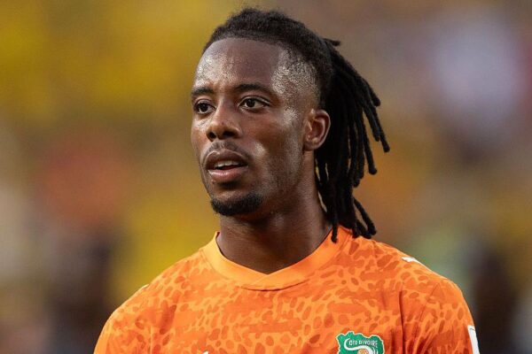 Ivory Coast striker Elye Wahi reacts during a World Cup match after being ruled out of the Germany fixture due to visa issues.