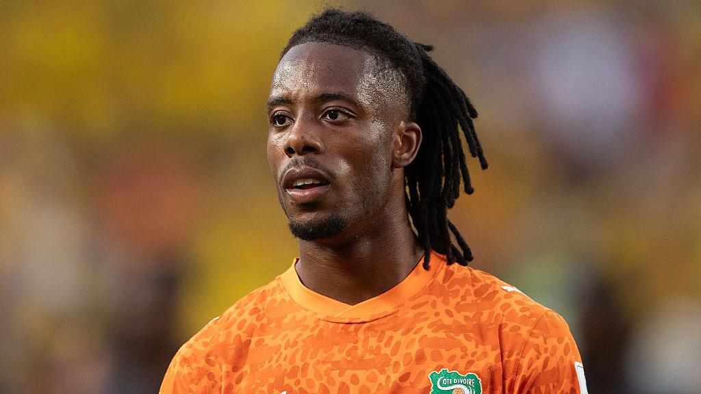 Ivory Coast striker Elye Wahi reacts during a World Cup match after being ruled out of the Germany fixture due to visa issues.
