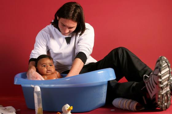 Lionel Messi bathing baby Lamine Yamal during a UNICEF charity photoshoot in 2007.