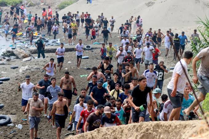 Migrants gather near the Spain-Morocco border in Ceuta during the latest migration crisis.