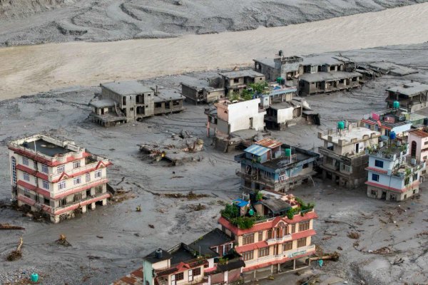 Floodwaters and mud cover communities in Nepal after a suspected glacier collapse