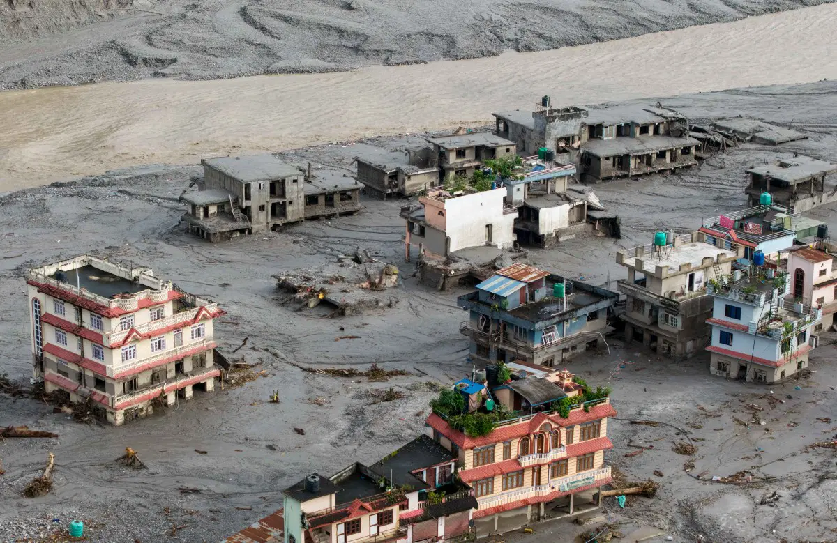 Floodwaters and mud cover communities in Nepal after a suspected glacier collapse