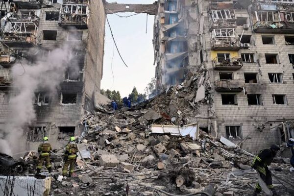 Emergency responders search damaged residential buildings after Russian missile strikes in Kyiv.