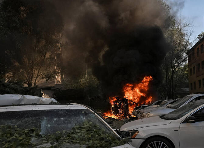 Emergency responders at the scene of damage following fresh strikes in the Ukraine-Russia conflict.