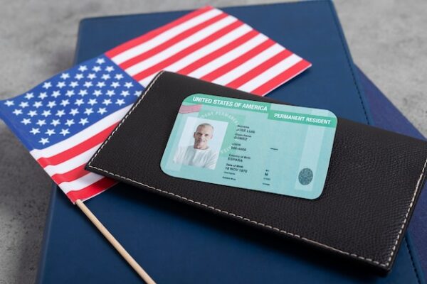 US green card and passport representing new public charge immigration rules
