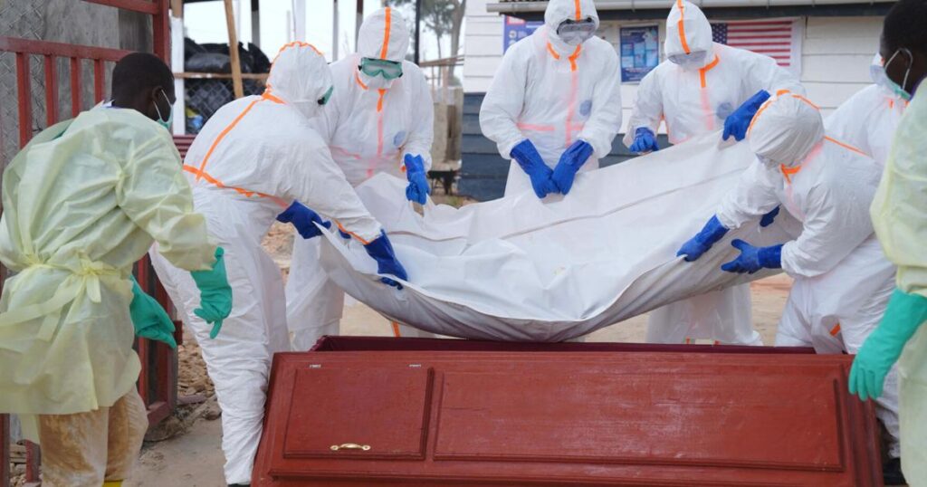 Health workers in protective equipment train on Ebola evacuation protocols in Kenya