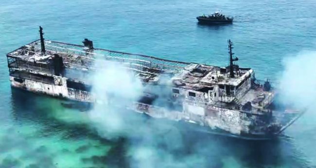 Damaged ferry after a fire off Palawan in the Philippines as rescue teams search for 87 missing passengers and crew.